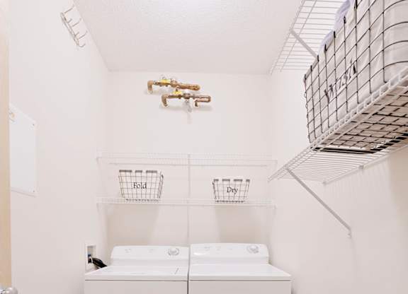 A small laundry room with a washer and dryer.