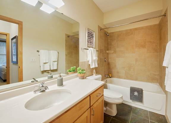 A bathroom with a white sink, toilet, and bathtub.