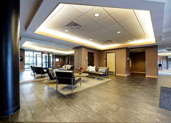 A spacious lobby with a seating area and a large mirror.