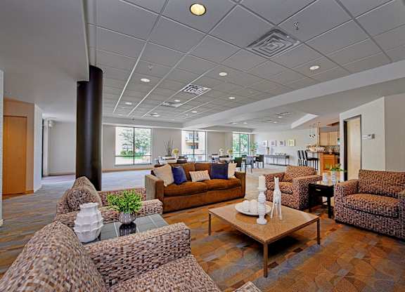 A lobby with chairs, a sofa, and a coffee table.