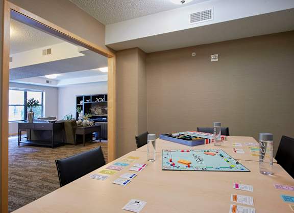 A conference room with a long table and a board game on it.