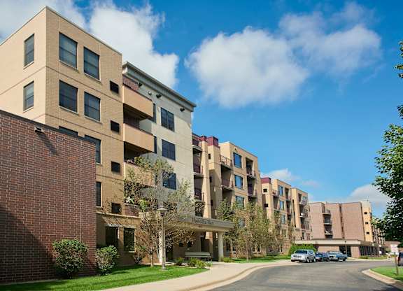 Apartment buildings with a clear blue sky above them.