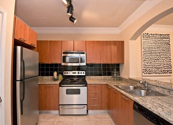 a kitchen with a stove refrigerator and a sink