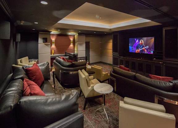 a living room with couches and chairs and a television