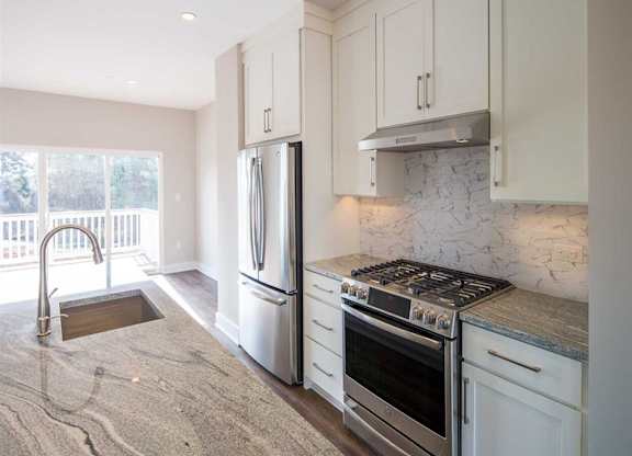 A kitchen with a countertop and stainless steel appliances at City Center Townes