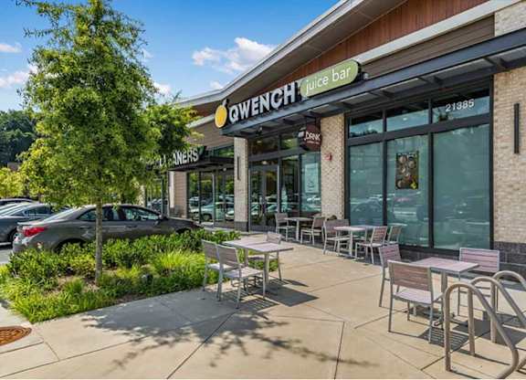 a patio outside of a restaurant with tables and chairs