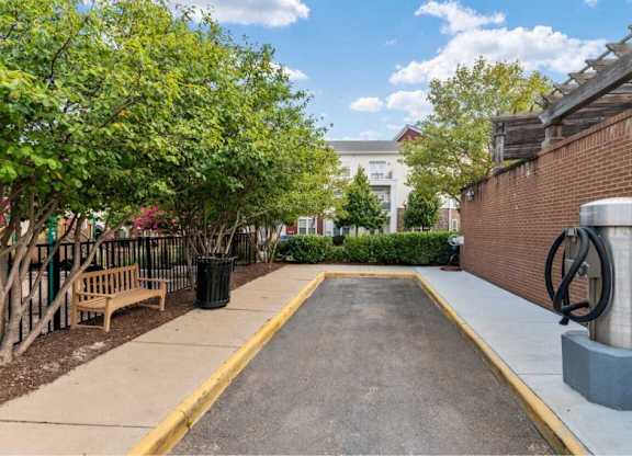 the courtyard of a building with a bench and a fountain