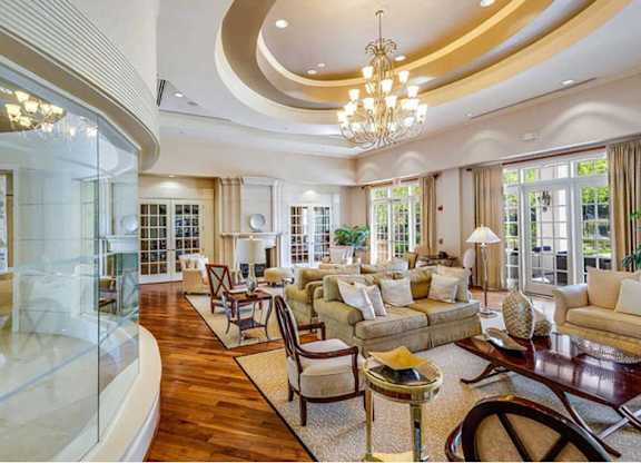 a living room filled with furniture and a glass door
