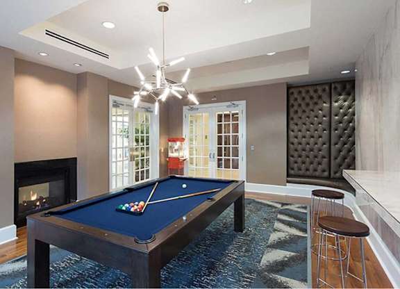 a game room with a pool table and a fireplace