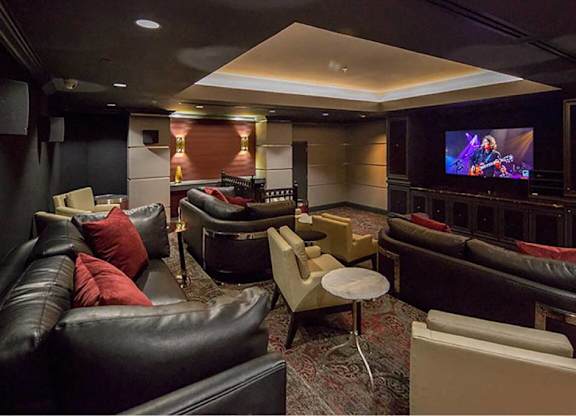 a living room with couches and chairs and a television