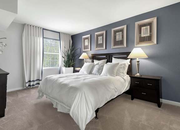bedroom with blue walls and a white bed