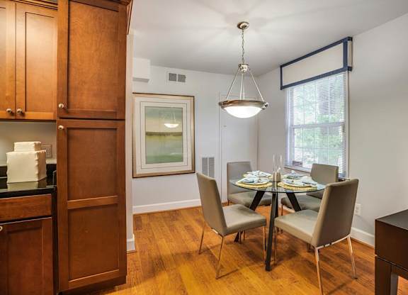 a dining room with a table and chairs