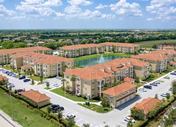 an aerial view of an apartment complex next to a lake