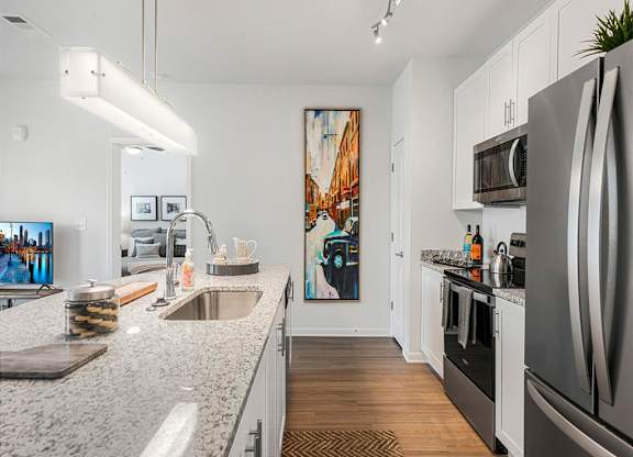 a kitchen with granite counter tops and stainless steel appliances