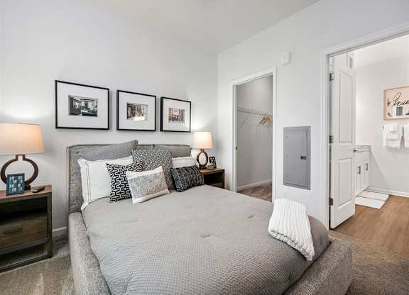 a bedroom with a bed and some pictures on the wall