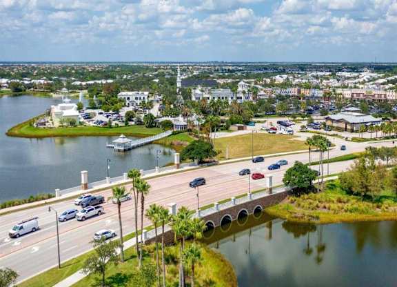 a bridge over a body of water with a city in the background