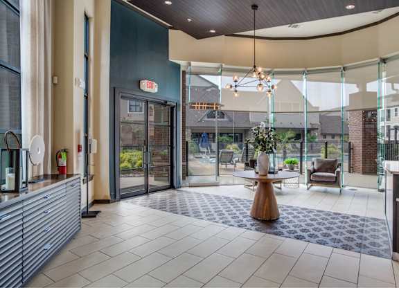 A modern lobby with a wooden table and chairs.