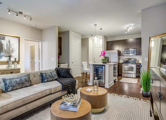 A modern living room with a beige couch and a coffee table.