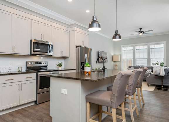 A kitchen with a bar area and a dining table.