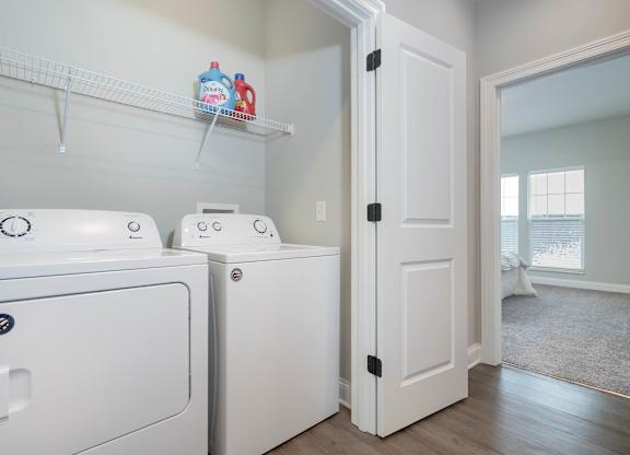 A white washing machine and dryer in a laundry room.