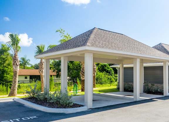 A building with a parking lot in front of it at Mode at Melbourne, LLC Apartments, Melbourne, Florida