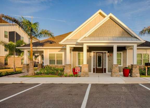 A building with a brown roof and a white entrance at Mode at Melbourne, LLC Apartments, Florida