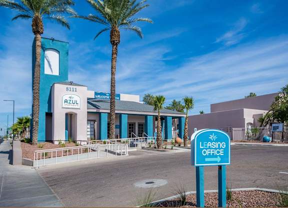 A blue and white building with a sign that says
