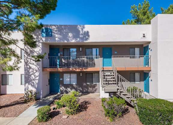 A modern apartment building with blue doors and windows.