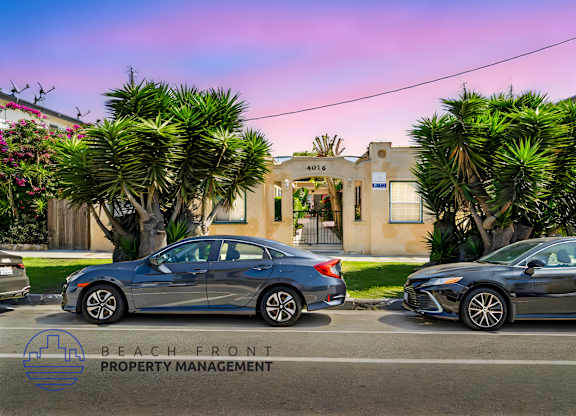 Two cars parked in front of a building with the text