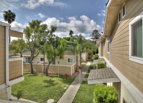 A sunny day in a residential area with houses and trees.