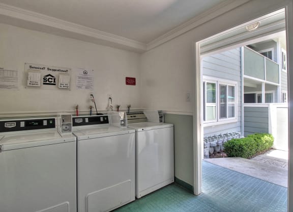 A laundry room with washer and dryer machines.