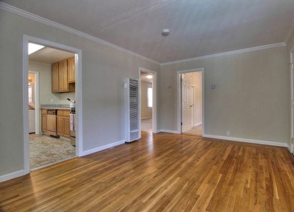 A room with wooden floors and white walls.