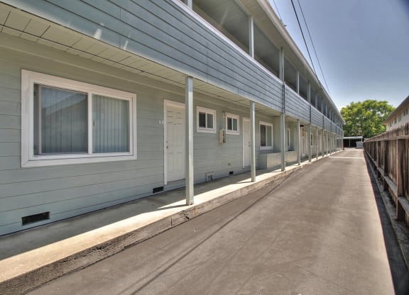 A long row of houses with grey siding and white trim.