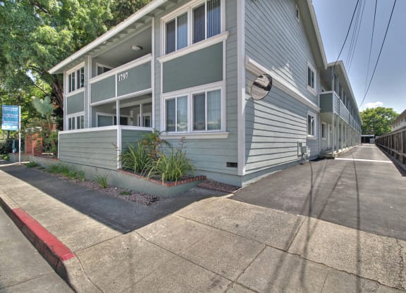 A street view of a residential area with apartment buildings.