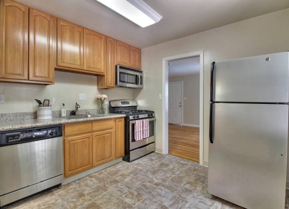 A kitchen with wooden cabinets and stainless steel appliances.