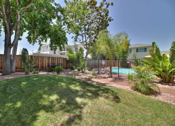 a backyard with a pool and a wooden fence
