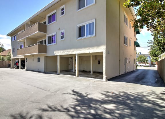 an empty parking lot in front of an apartment building