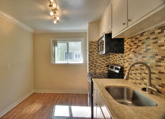A kitchen with a sink and a window.