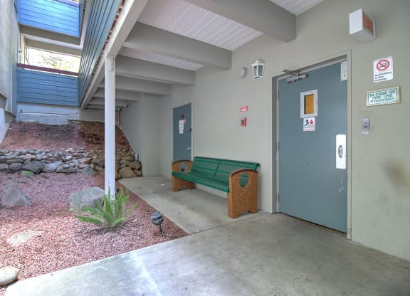 A small courtyard with a bench and a door.