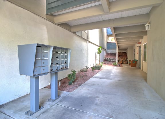 A long hallway with a mailbox on the left.