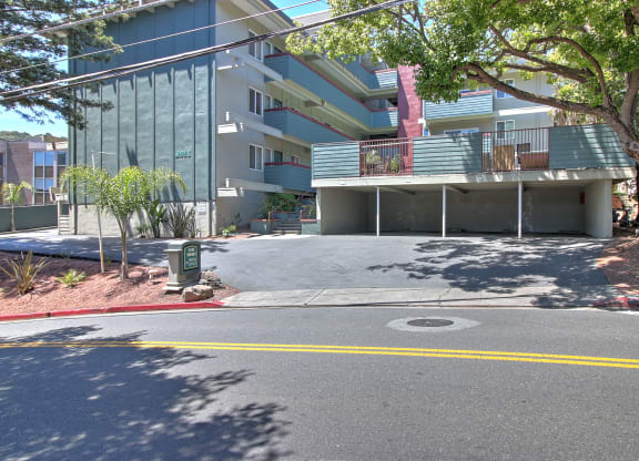 A street view of a residential area with apartment buildings.