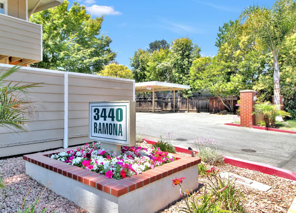 A sign that says 3440 Ramona is in front of a house.