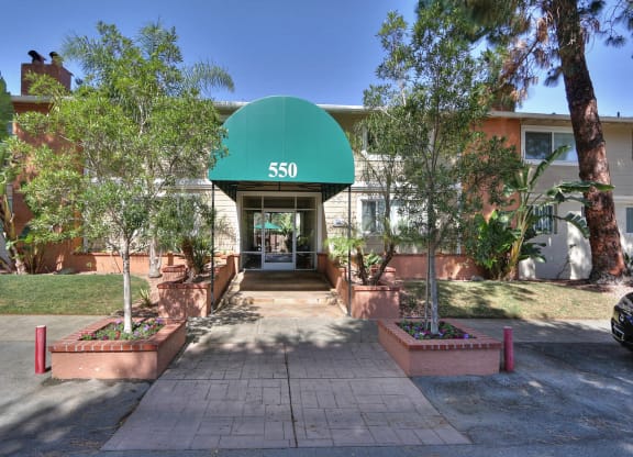 The entrance to apartment building 550 with a green awning.