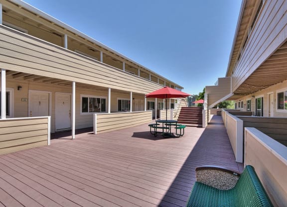 a large deck with a red umbrella on it