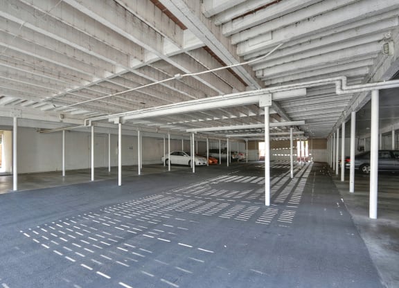 an empty parking garage with white columns