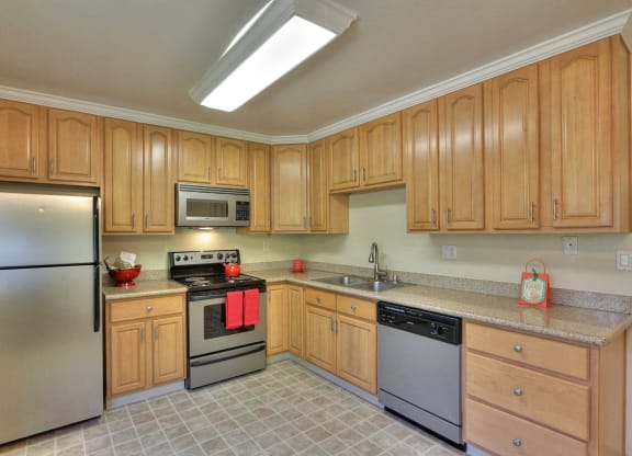 a kitchen with stainless steel appliances and wooden cabinets