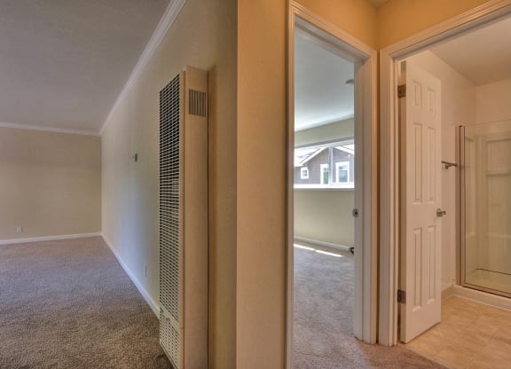 an empty living room with a closet and a door to a bedroom