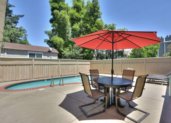 our patio has a table with chairs and an umbrella
