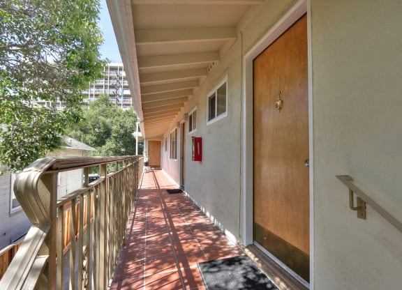a long porch with a door to a balcony