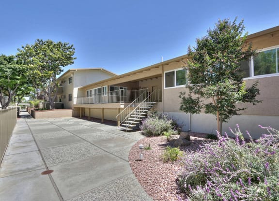 A building with a concrete walkway in front of it.
